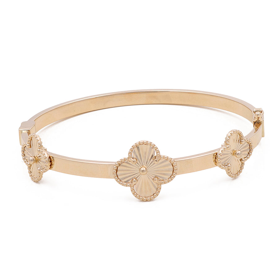 Miral Jewelry's 14K gold tiara with three floral designs adorned with small gemstones on a white background.