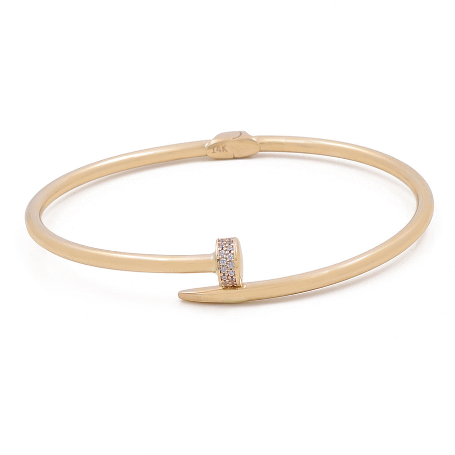 Miral Jewelry's 14K Gold Fashion Nail Bracelet with Cubic Zirconias features a diamond-encrusted head.