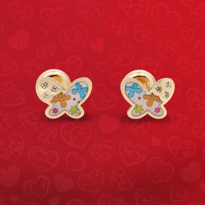 A pair of gold - plated butterfly stud earrings on a red background.