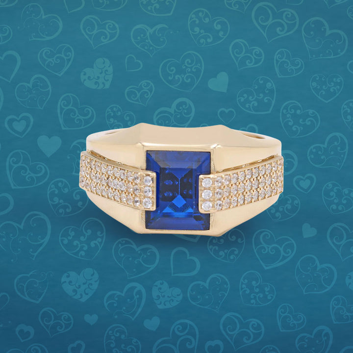 A gold ring with a blue sapphire and diamonds.