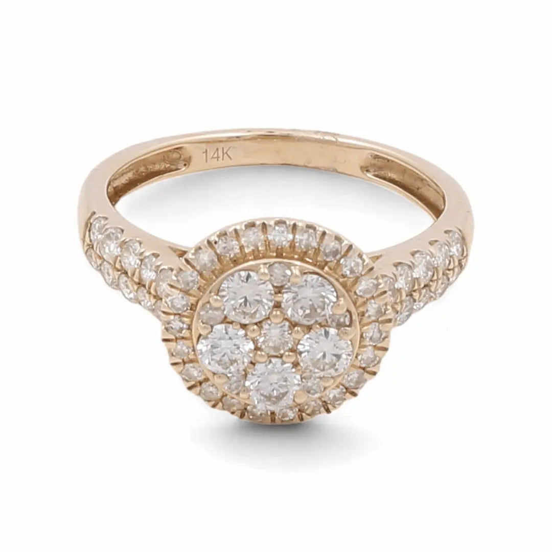 Introducing the 14K Yellow Gold Bridal Woman Ring with Diamonds by Miral Jewelry. This stunning ring showcases a round cluster of small diamonds set at the center, enhanced by additional diamonds encrusting the band. Ideal for engagements or anniversaries, it is marked with "14K" to signify its quality.