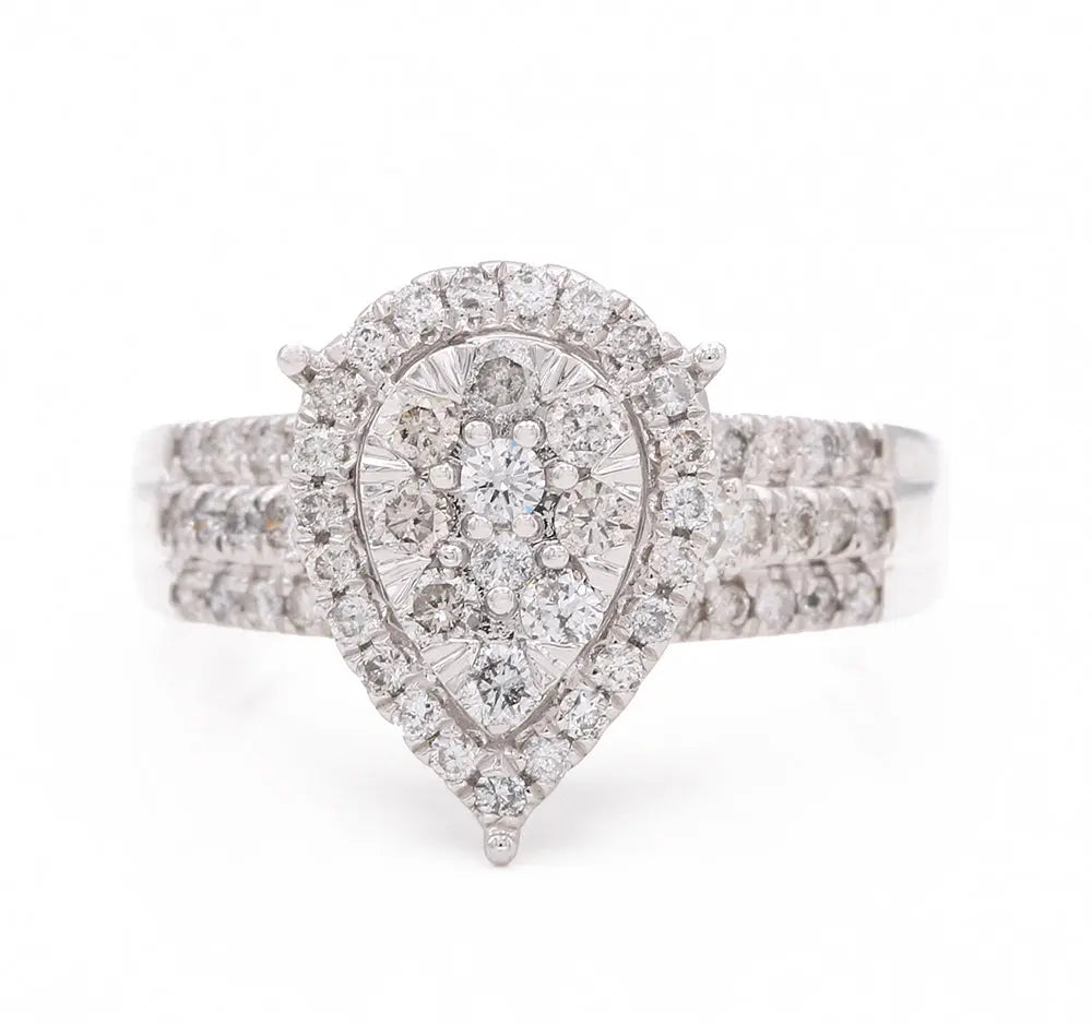 A Miral Jewelry contemporary engagement ring with a pear-shaped diamond set in 14K yellow gold.