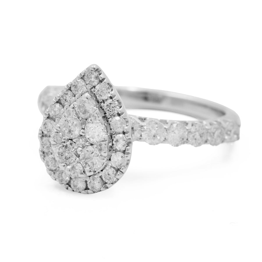 An elegant Miral Jewelry 14K White Gold Women's Contemporary Diamond Engagement Ring adorned with a stunning pear-shaped diamond.