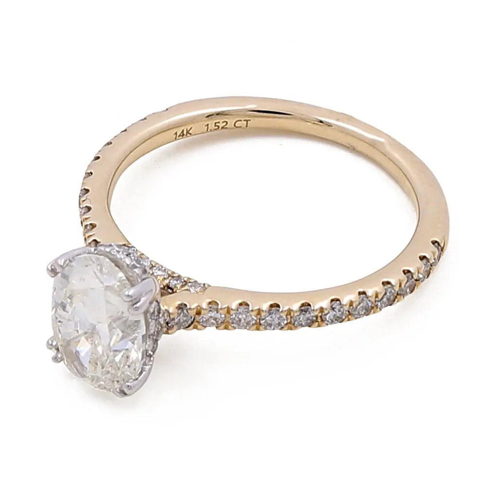 A 14K yellow gold engagement ring featuring a large oval-cut diamond centerpiece and smaller diamonds adorning the band. The inner side of the band is engraved with "14K 1.52 CT." This exquisite Miral Jewelry 14K Yellow Gold Women's Contemporary Engagement Ring 1.52 Oval Diamonds-0.64Tw Round Diamonds embodies contemporary elegance.
