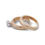 Two 14K yellow gold wedding bands by Miral Jewelry, each adorned with small diamonds, and one Miral Jewelry 14K Yellow Gold Bridal Woman Ring featuring a single large diamond, displayed against a plain background. Ideal for the discerning woman seeking the perfect bridal ring set.
