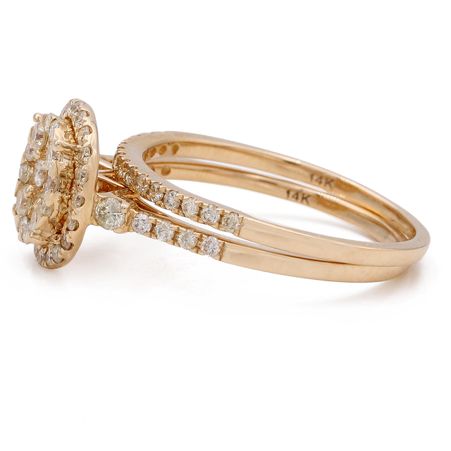 A Miral Jewelry contemporary engagement ring set with a cluster of diamonds in 14K yellow gold.