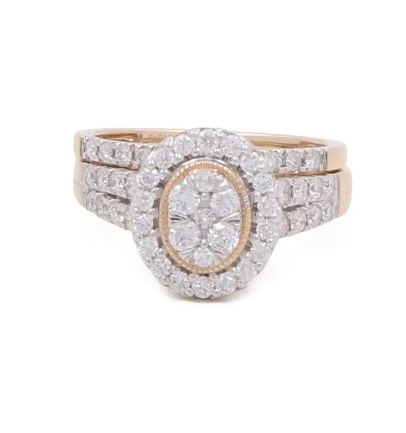 Introducing the 10K Yellow Gold Bridal Woman Ring with Diamonds by Miral Jewelry. This exquisite piece features a double halo of small diamonds encircling a central oval cluster of dazzling diamonds. Part of our luxurious collection, this ring exudes timeless elegance and sophistication.
