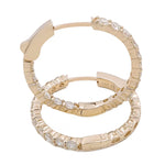 Close-up of the 14K Yellow Gold Hoops Earrings With 2.00Tw Round Diamonds by Miral Jewelry, adorned with sparkling round diamonds. Each earring is marked with "14K," indicating the gold purity, making it a timeless piece of jewelry.