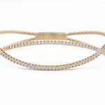A Miral Jewelry Yellow Gold 14K Fancy Bangle Bracelet With Diamonds.