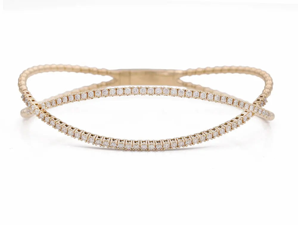 A Miral Jewelry Yellow Gold 14K Fancy Bangle Bracelet With Diamonds.
