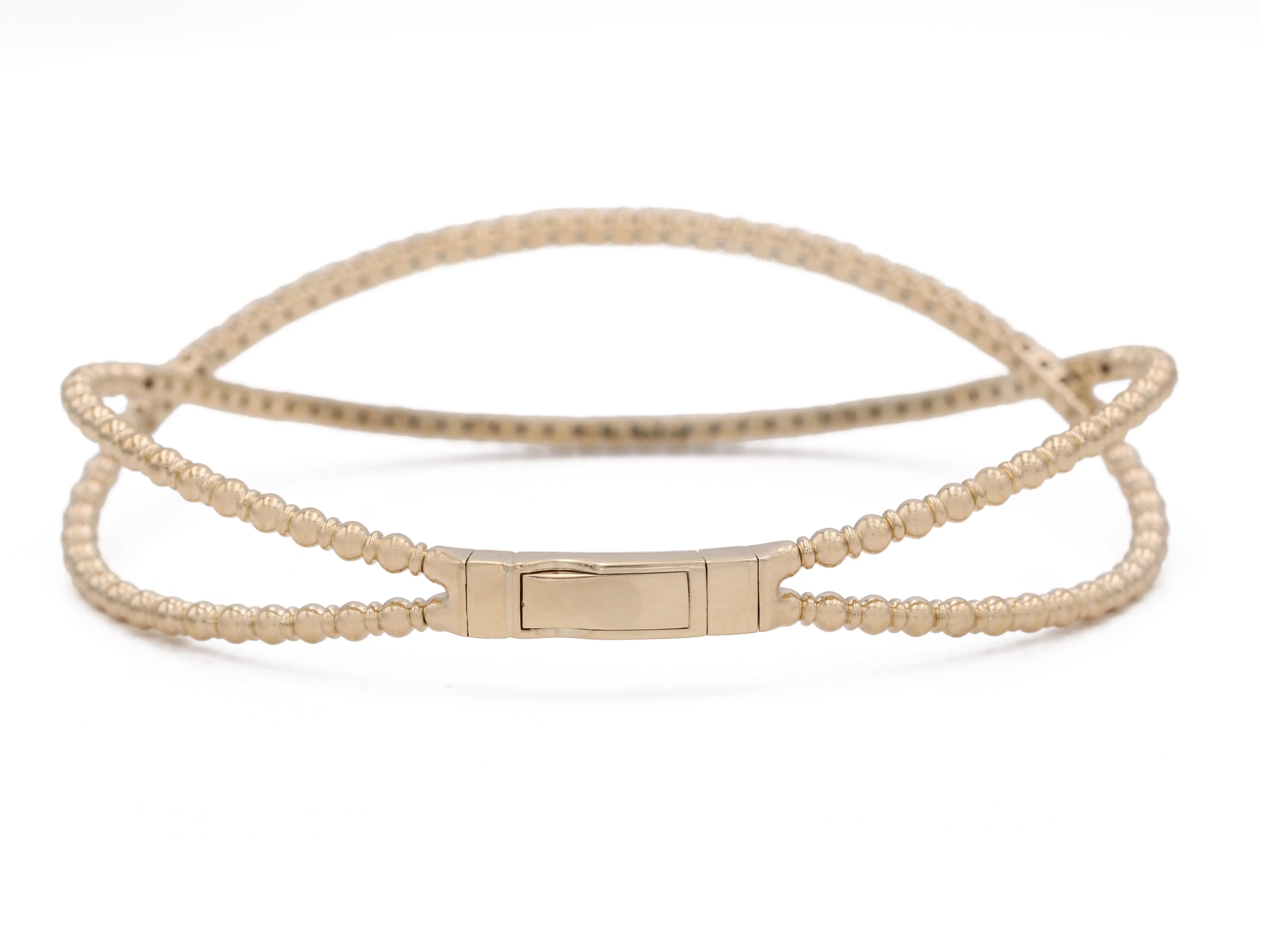 A Yellow Gold 14K Fancy Bangle Bracelet With Diamonds with a clasp by Miral Jewelry.