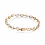 Introducing the Miral Jewelry's exquisite 14K yellow gold bracelet, adorned with a series of oval-shaped aqua stones and finished with a secure clasp closure.
