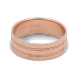 An elegant men's wedding ring in 14K rose gold from Miral Jewelry, featuring textured bands and engraved with "G14KP" on the inner surface.