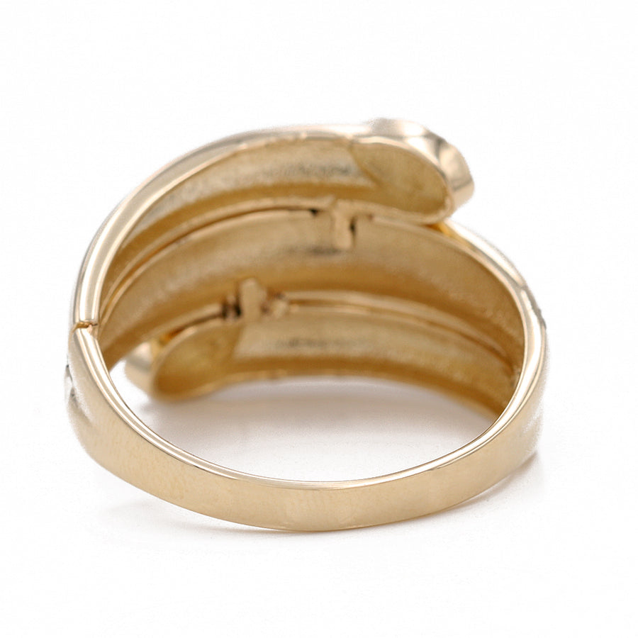 A smooth 14K yellow gold Miral Jewelry ring with diamonds on it.