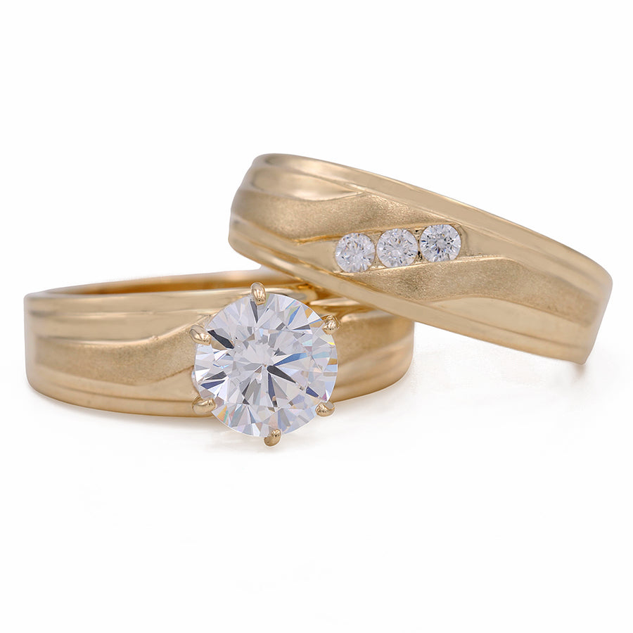 A Miral Jewelry Yellow Gold 14K Bridal Set With Cz with a diamond in the center.