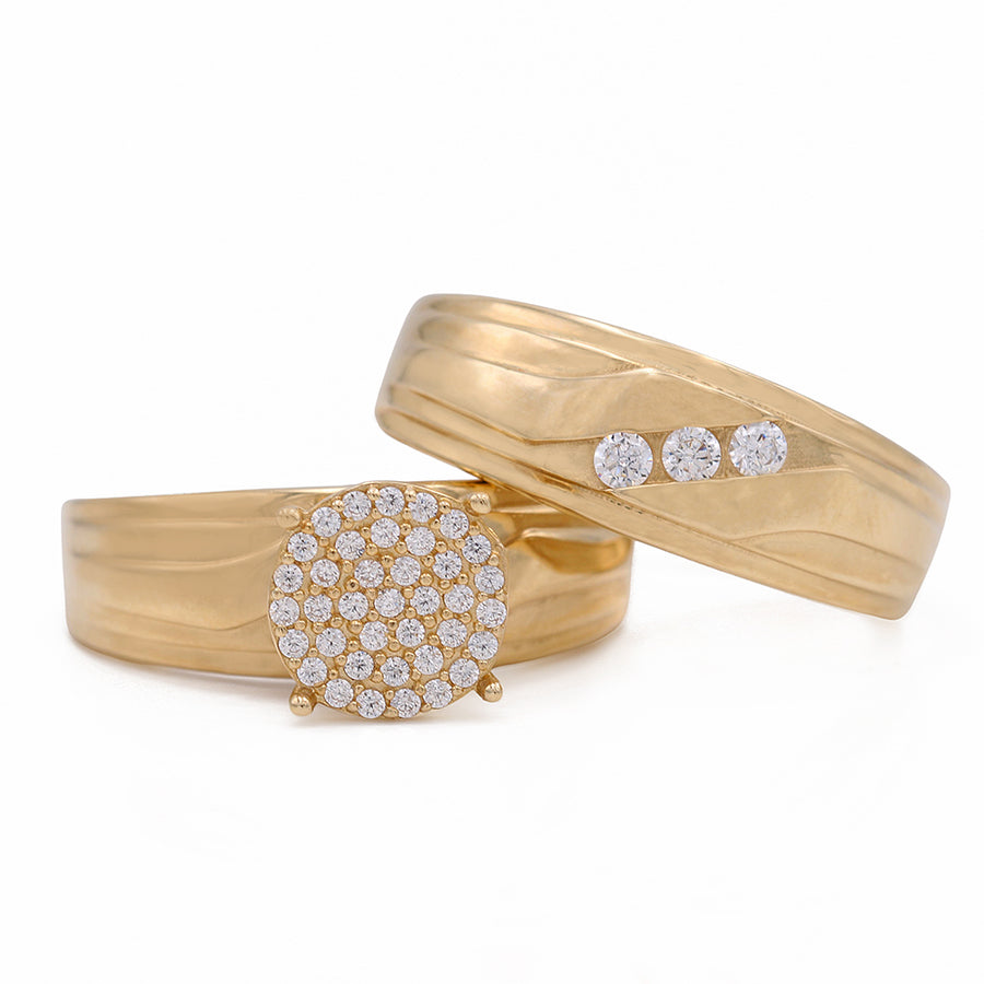 A stunning Yellow Gold 14K Bridal Set With Cz featuring a pair of yellow gold rings adorned with sparkling diamonds, available at Miral Jewelry.