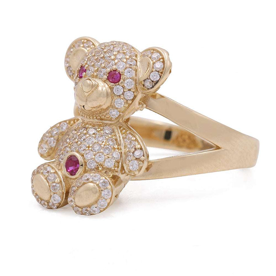 This exquisite Miral Jewelry Women's Yellow Gold 14K Bear Fashion Ring With Cz features a gold teddy bear adorned with rubies and diamonds, creating a captivating piece of jewelry.