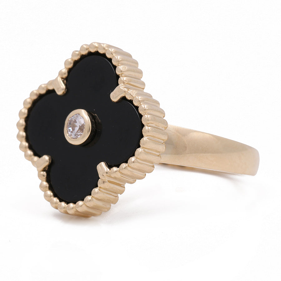 A Women's Yellow Gold 14K Flower Ring With Onyx Stone and Cz, elegantly crafted by Miral Jewelry, adorned with a diamond in the center.