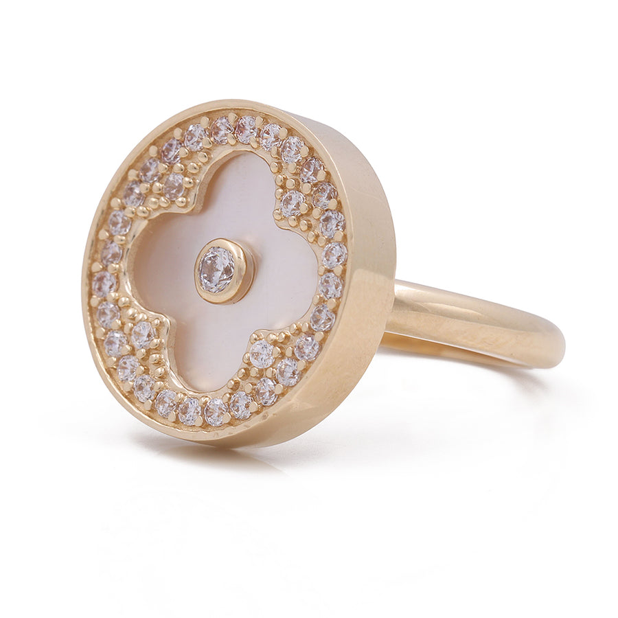 A Women's Yellow Gold 14K Flower Ring With Mother Pearl and Cz from Miral Jewelry is a timeless fashion ring adorned with a white mother of pearl and diamonds.