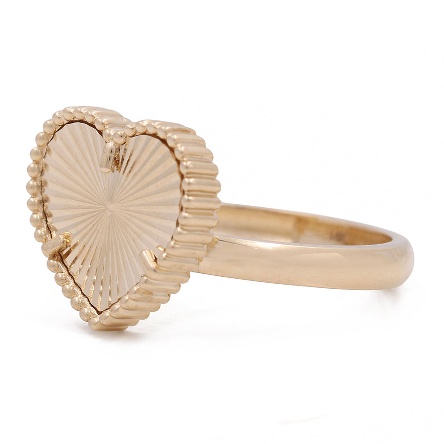 This Women's Yellow Gold 14K Heart Fashion Ring by Miral Jewelry features a heart-shaped design, making it a fashionable and timeless piece.