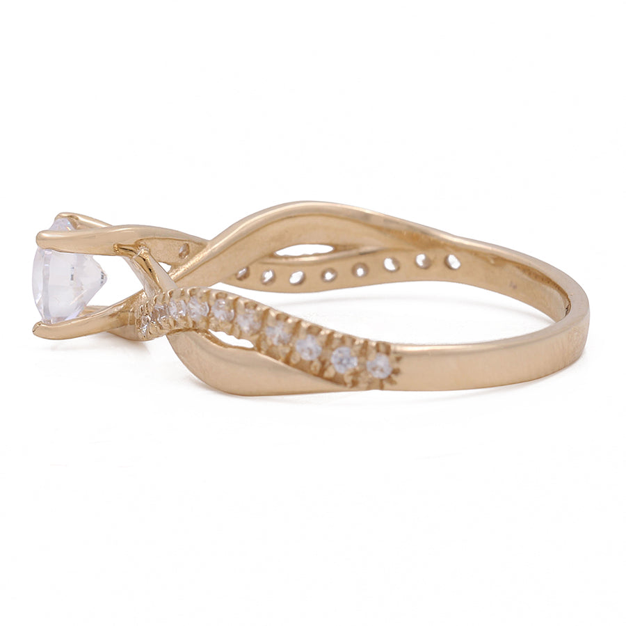 A Miral Jewelry yellow gold 14K engagement ring with a white stone and diamonds.