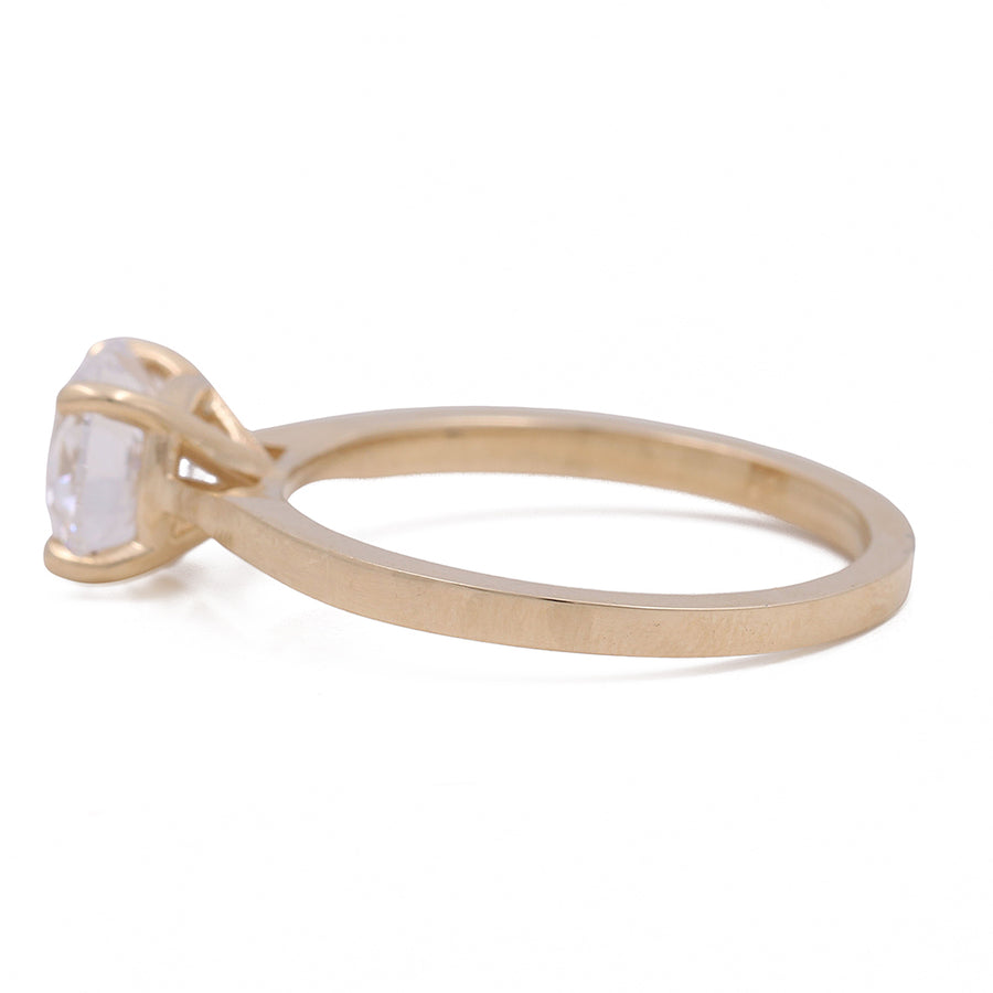 A Miral Jewelry yellow gold 14K engagement ring with a white topaz stone.