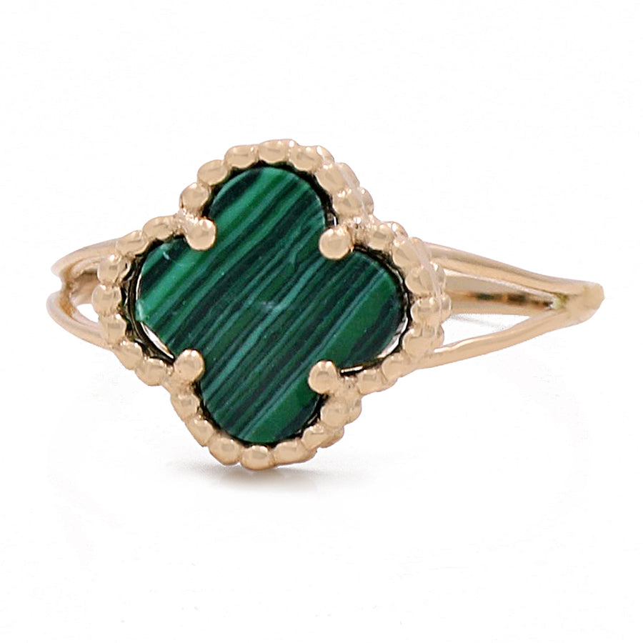 A 14K Yellow Gold Fashion Flower Women's Green Stone Ring set in yellow gold by Miral Jewelry.