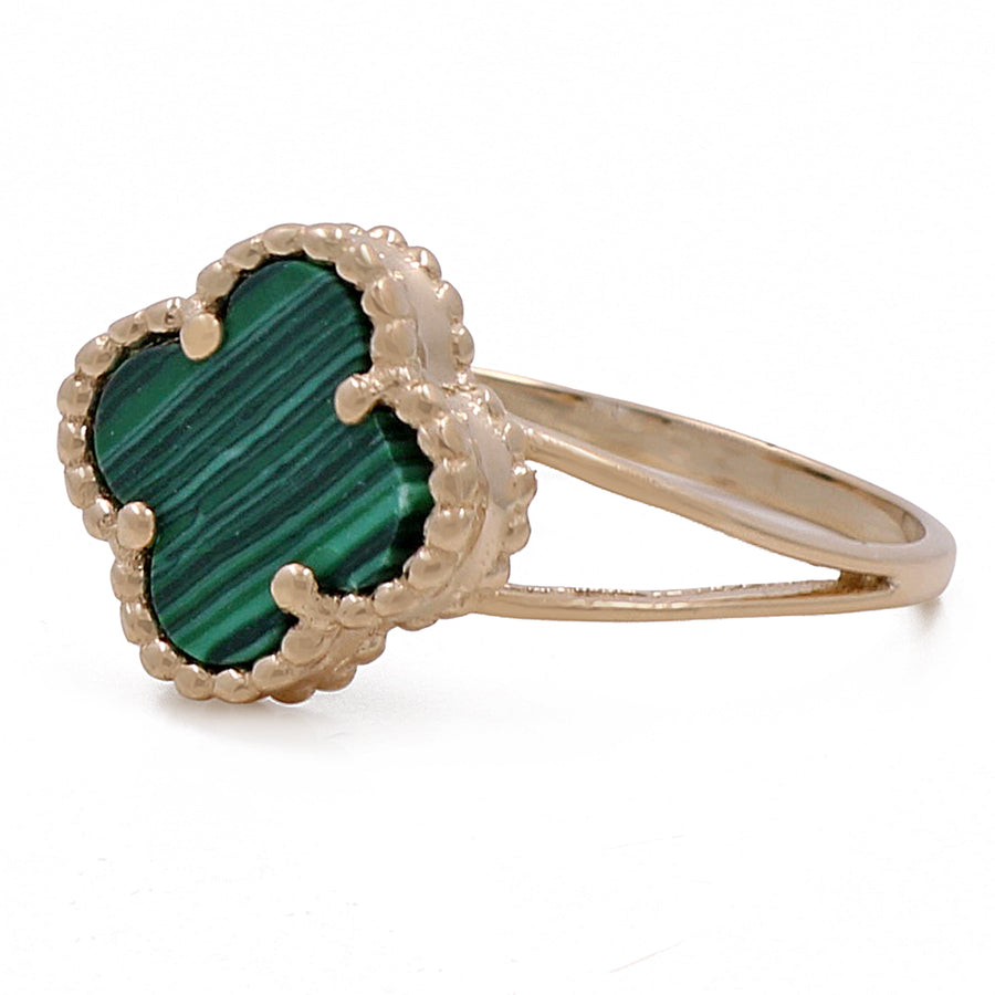 A 14K yellow gold fashion flower women's green stone ring by Miral Jewelry is a stylish and elegant accessory.