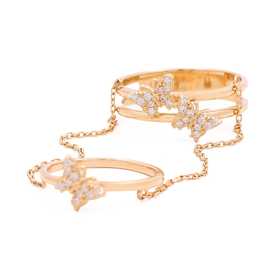 An elegant Miral Jewelry 14K Yellow Gold Butterfly Ring Set with Chain and Cubic Zirconias.
