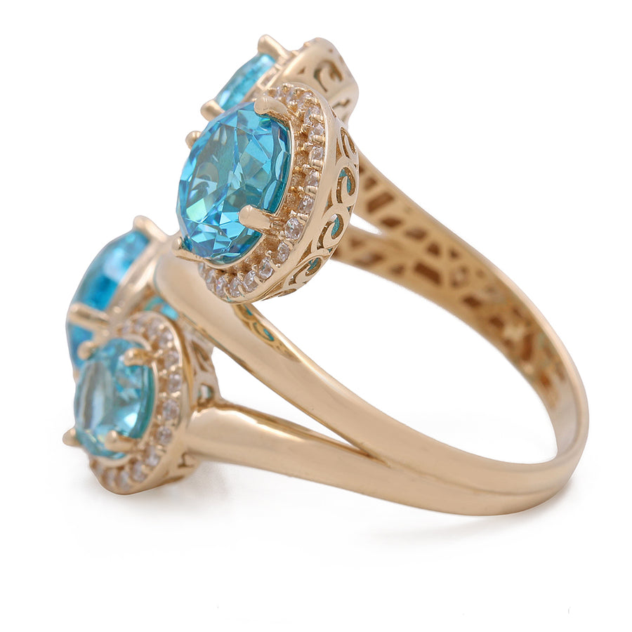 A 14K Yellow Gold Women's Fashion Blue Stones Ring with Cubic Zirconias from Miral Jewelry featuring blue topaz and diamonds.