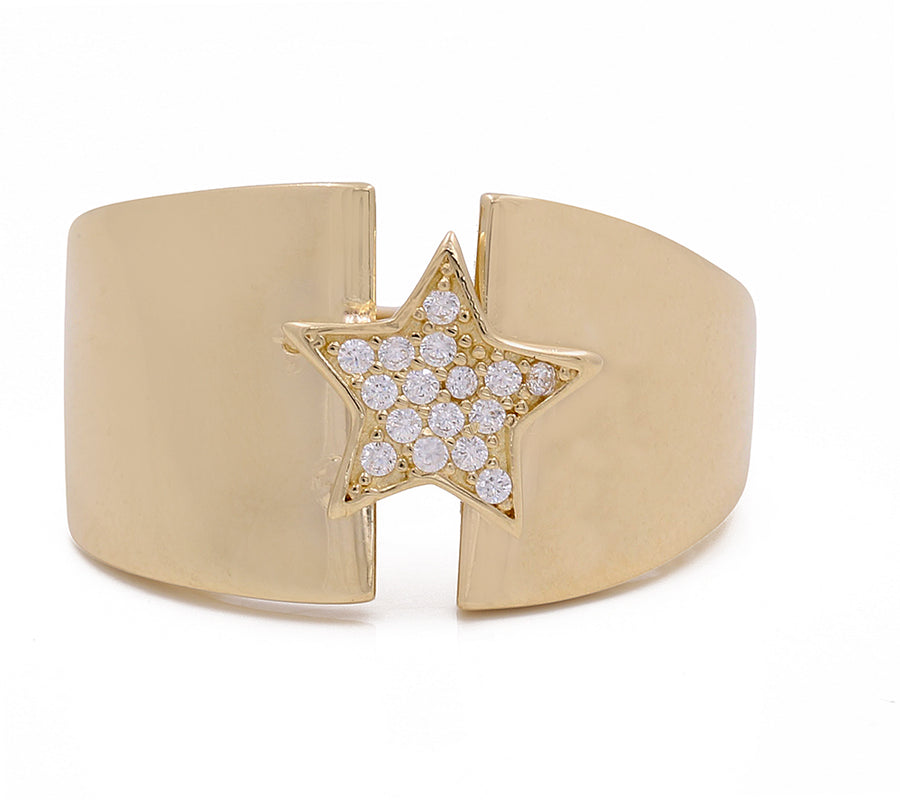 A Miral Jewelry star-shaped gold cuff ring with diamonds, adding a touch of luxury to any outfit.