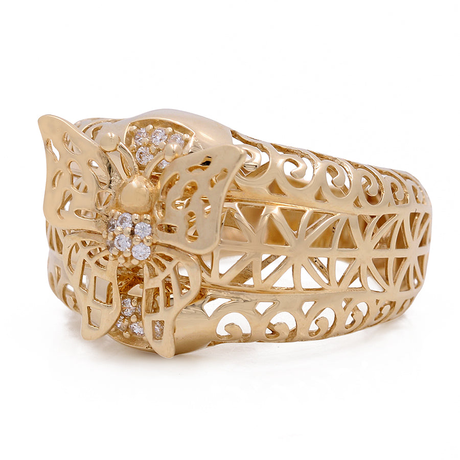 A fashion-forward Miral Jewelry butterfly ring in yellow gold adorned with sparkling diamonds.