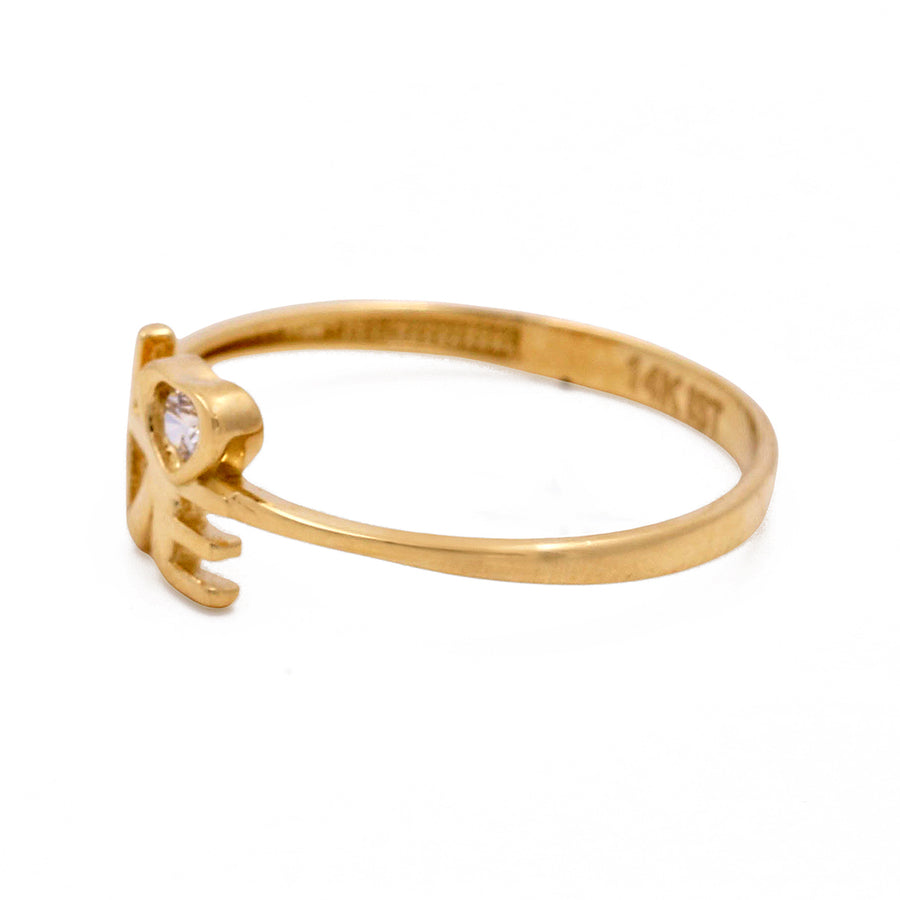 Miral Jewelry's 14K Yellow Gold Fashion Love Women's Ring with Cubic Zirconias features a single clear stone on a white background.
