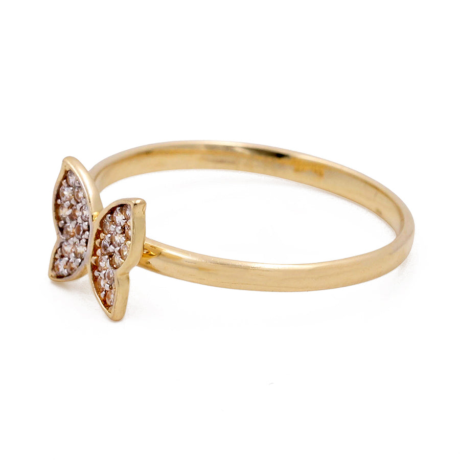 Miral Jewelry's 14K Yellow Gold Fashion Butterfly Women's Ring with Cubic Zirconias is adorned with small cubic zirconias in a butterfly-shaped setting.