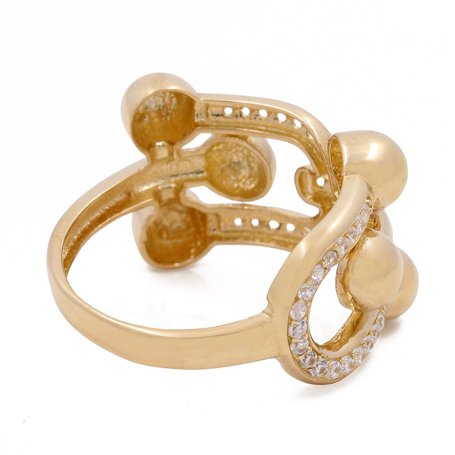 Miral Jewelry's 14K yellow gold ring with an abstract design and Cubic Zirconias accents.