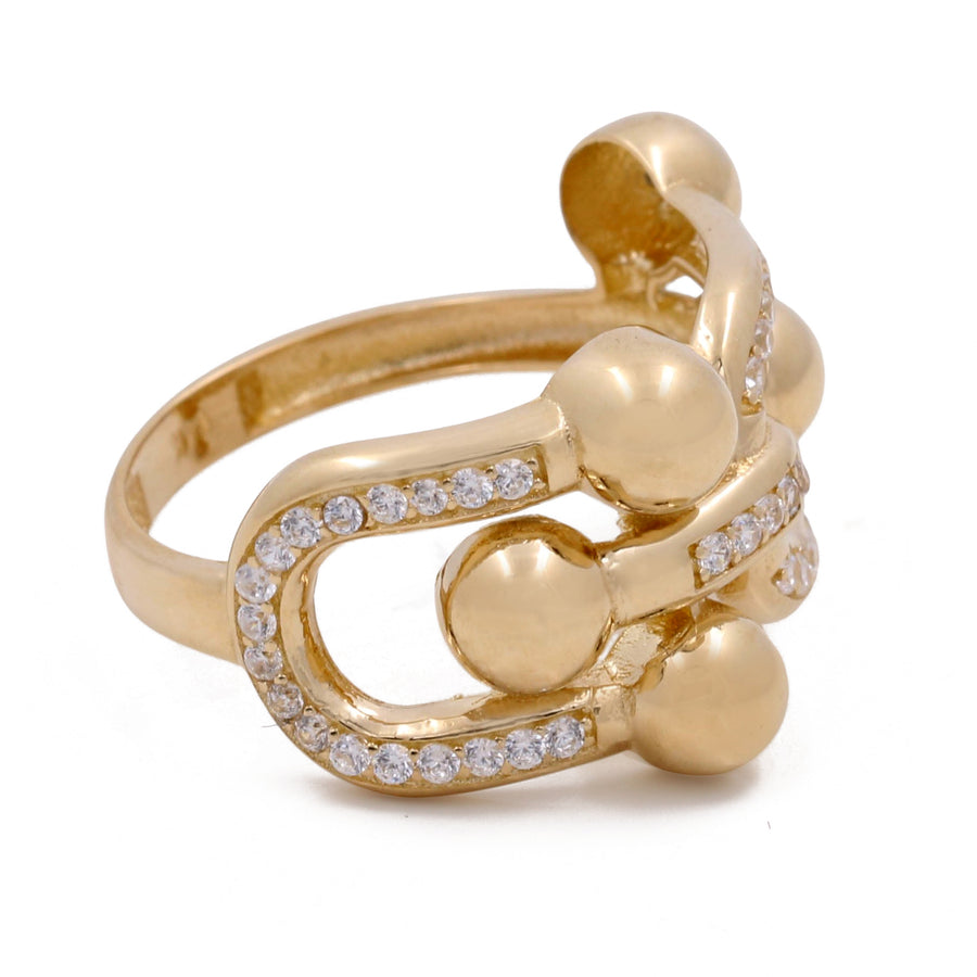 Miral Jewelry's 14K yellow gold ring with abstract design features polished spheres and a loop embellished with small cubic zirconias.