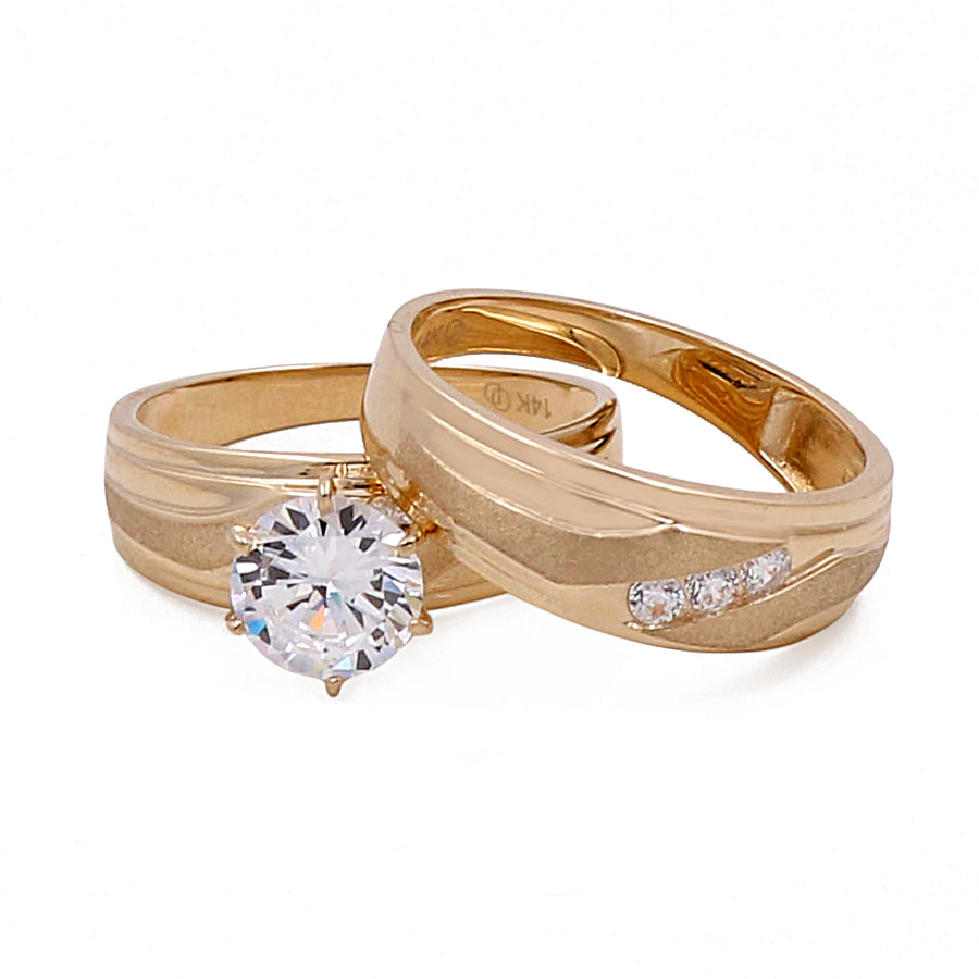 Two Miral Jewelry 14K yellow gold bridal sets with cubic zirconias, one featuring a large round-cut centerpiece.