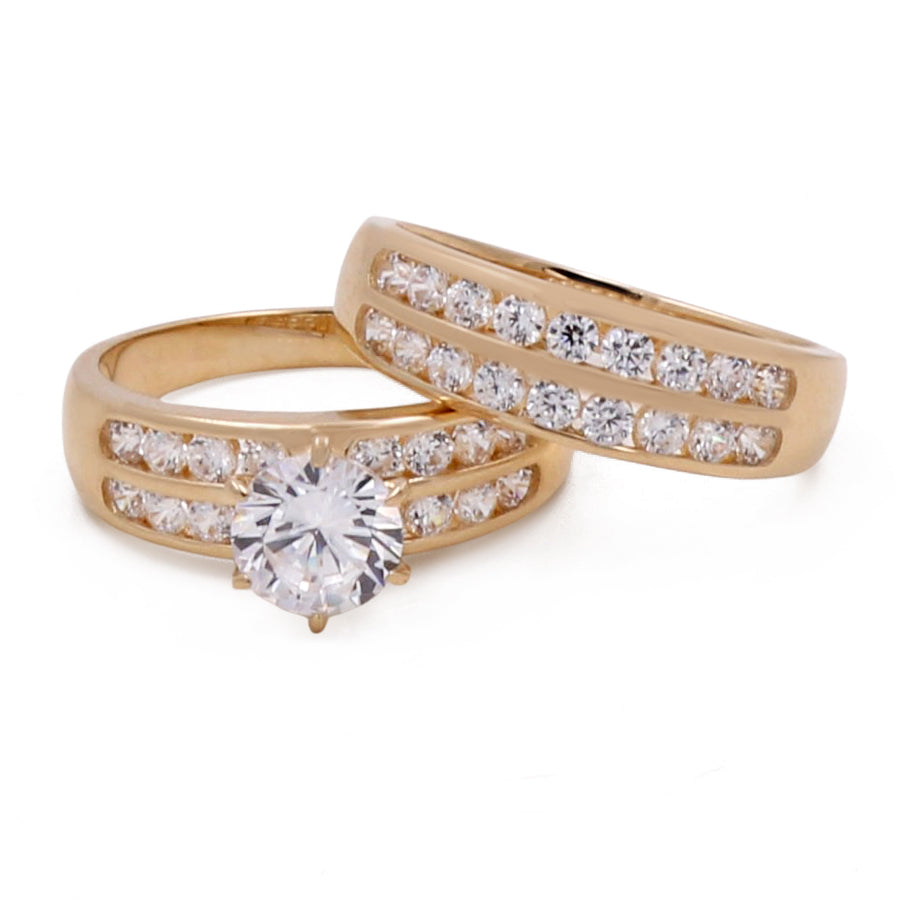 Miral Jewelry's 14K Yellow Gold Bridal Set with Cubic Zirconias features a central round diamond and an accompanying band adorned with smaller cubic zirconias.