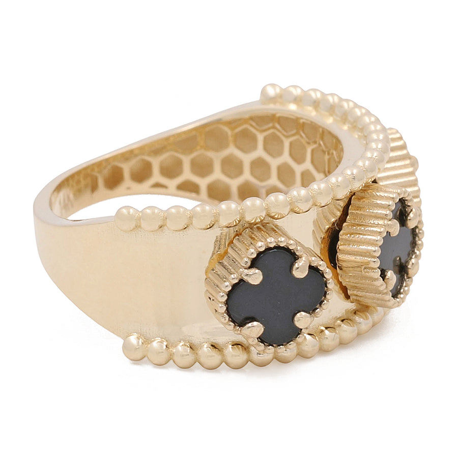 Miral Jewelry's 14K Yellow Gold Onyx Flowers Ring featuring a honeycomb design with black enamel detail and small Mother of Pearl embellishments.