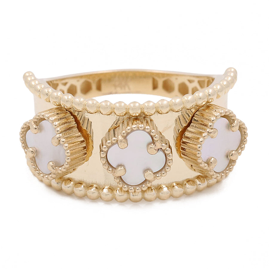 Miral Jewelry's 14K Yellow Gold Mother of Pearl Flowers Ring features pearl embellishments and clover-shaped cutouts with white enameled centers, on a white background.