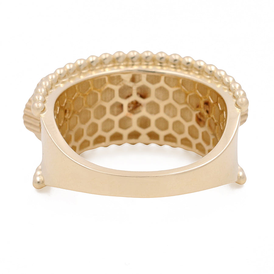 Miral Jewelry's 14K Yellow Gold Mother of Pearl Flowers Ring with a curved design and a honeycomb pattern cut-out, accented with small spherical beads along the edges.