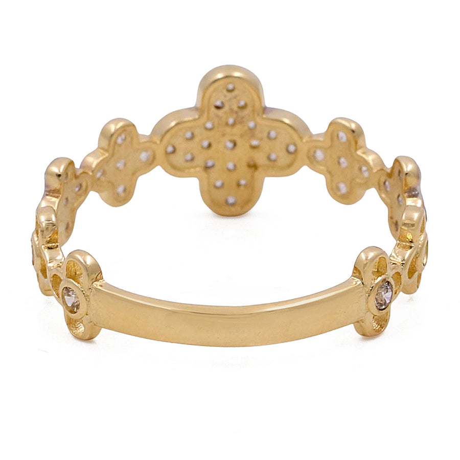 Gold bangle bracelet featuring gingerbread man and circular designs with small gemstone details, crafted from durable Miral Jewelry 14K yellow gold, displayed on a white background.