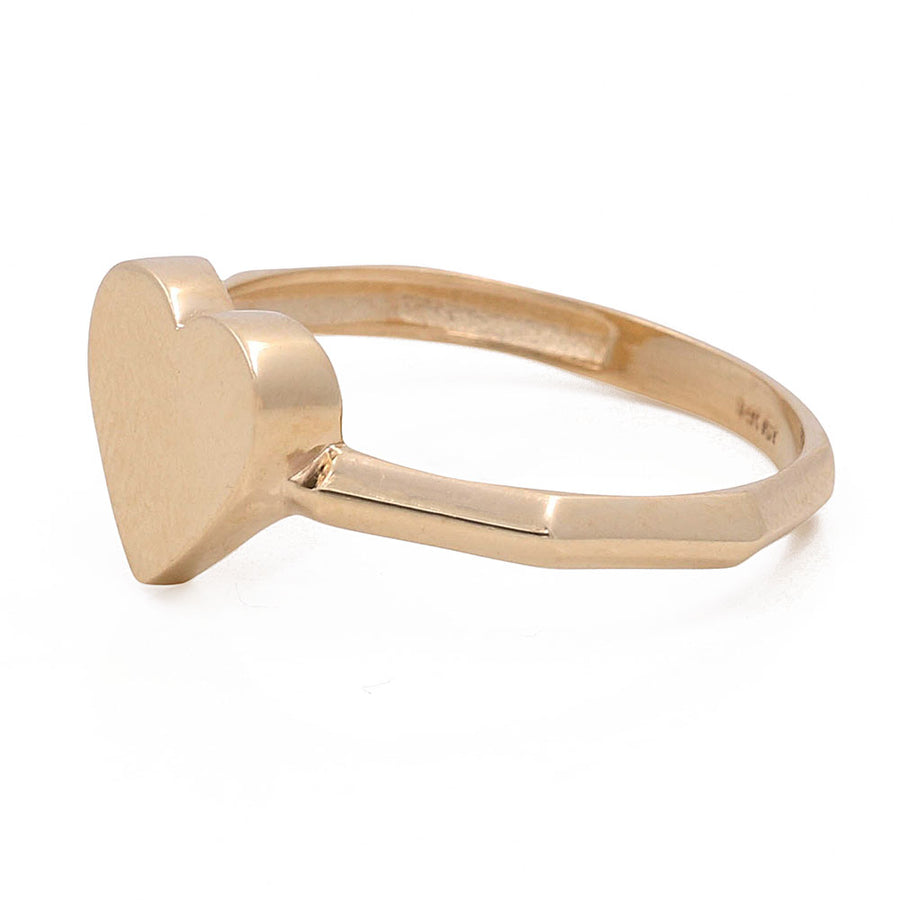 A simple Miral Jewelry 14K yellow gold heart ring with a heart-shaped head on a white background.