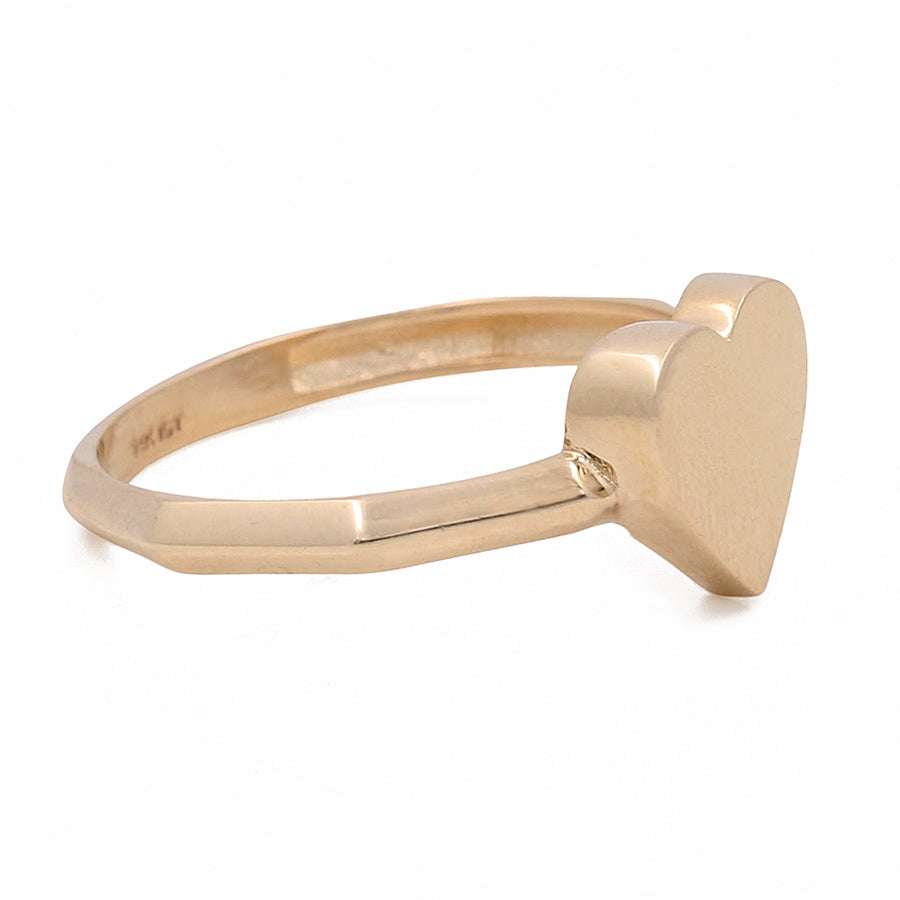 Miral Jewelry's 14K Yellow Gold Heart Ring with a heart-shaped top on a white background.
