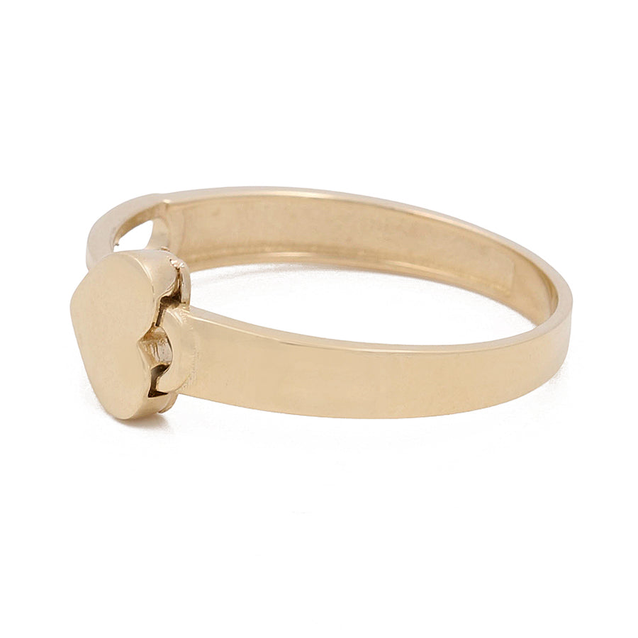 Miral Jewelry's 14K Yellow Gold Fashion Women's Ring features a simple band and a small, heart-shaped setting with a 14K yellow gold finish.