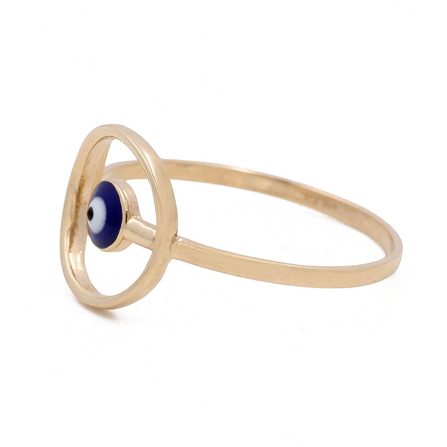 14K Yellow Gold Miral Jewelry Blue Evil Eye Ring with a circular frame holding a blue and white evil eye design, isolated on a white background.