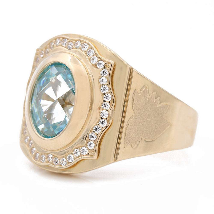 A Miral Jewelry yellow gold 14k fashion ring adorned with a stunning light blue topaz and accents of dazzling diamonds.