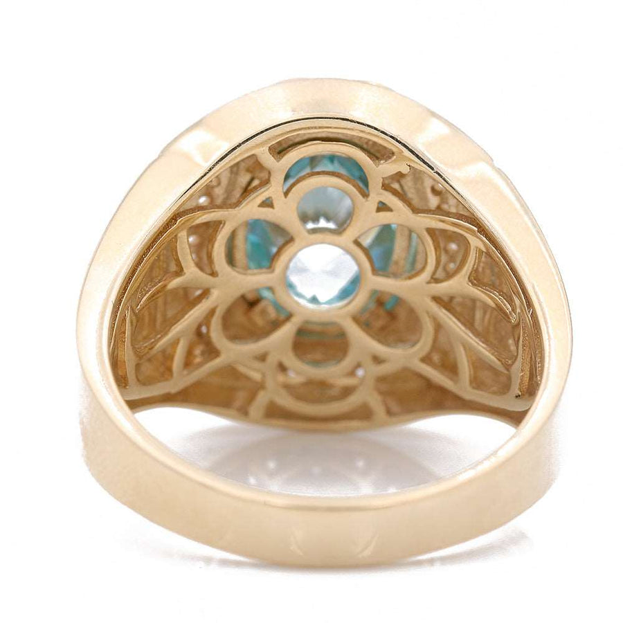 A Miral Jewelry yellow gold 14k fashion ring with a light blue topaz stone.