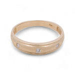 A 14K yellow gold men's wedding band from Miral Jewelry with a smooth, polished surface, featuring three evenly spaced round cubic zirconias around the band.