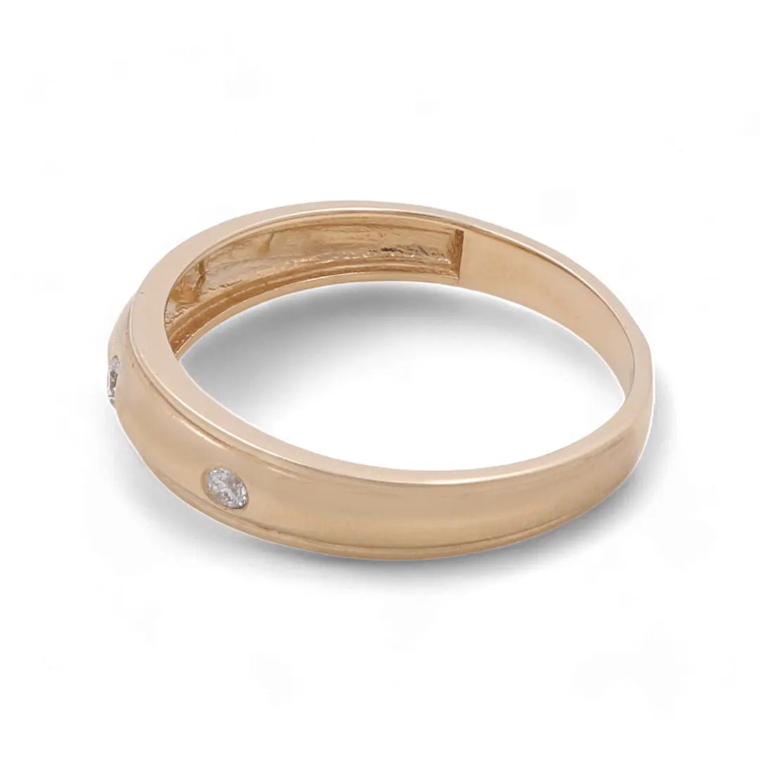 A 14K Yellow Gold Men's Wedding Band with embedded cubic zirconias by Miral Jewelry.
